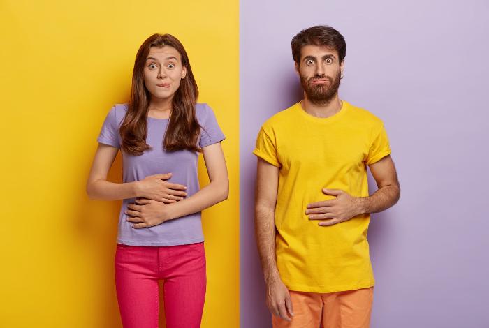 young-female-male-touch-stomaches-feel-satiety-after-eating-hearty-meal-bites-lips-have-good-appetite-dressed-casual-outfit-pose-against-yellow-purple-wall-pleasant-feeling-belly-1.jpg